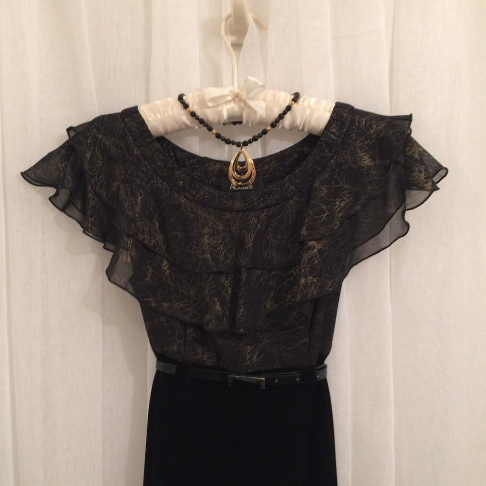 Black velvet, check.    Ruffles, check.    Gold details, check.